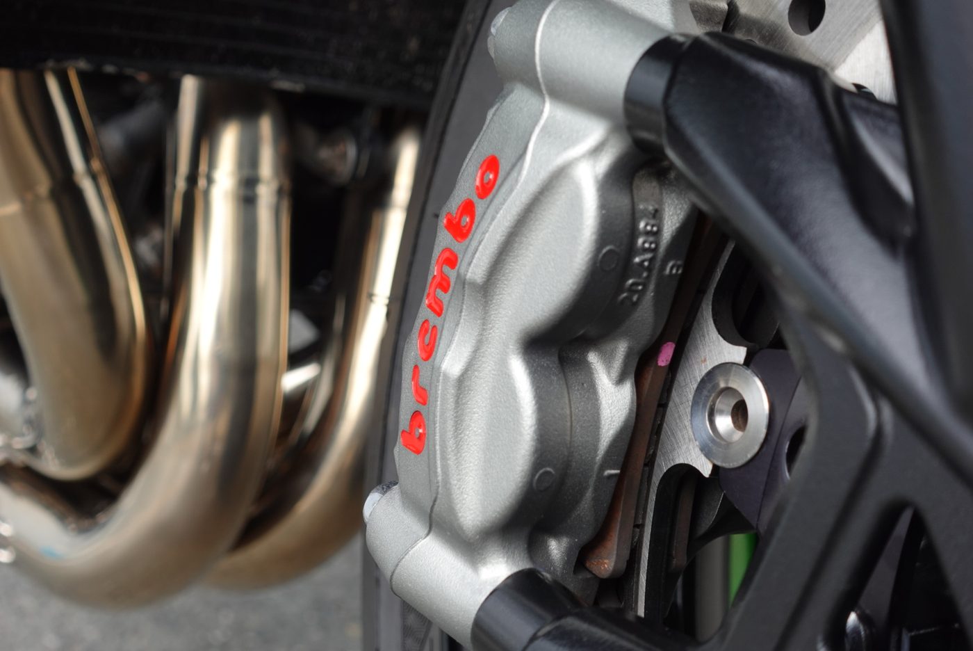 Brembo brake and exhaust detail on a supersport, cleaned and protected