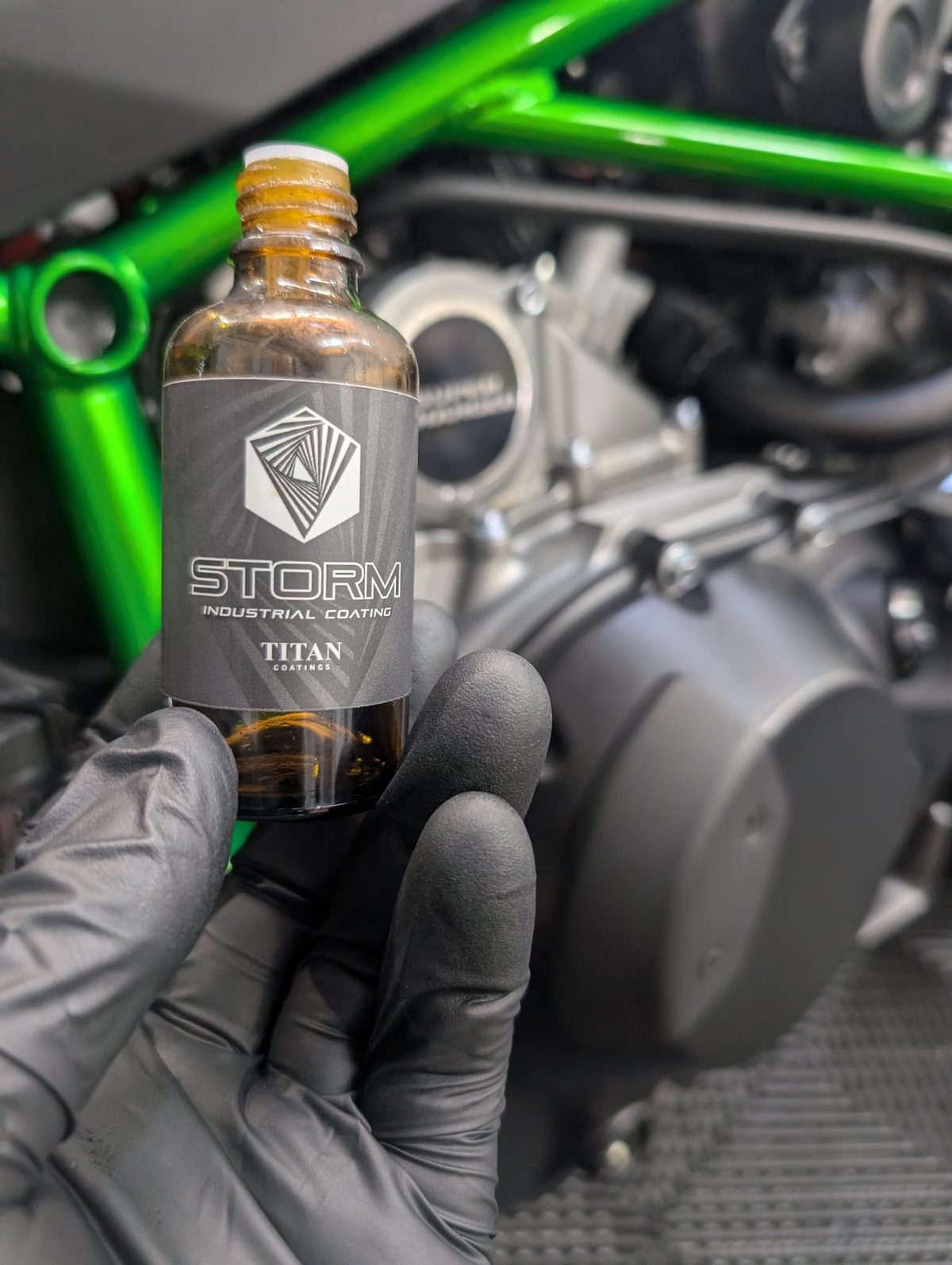 Titan Storm industrial ceramic coating being applied to a Kawasaki motorcycle at Doyen Voss